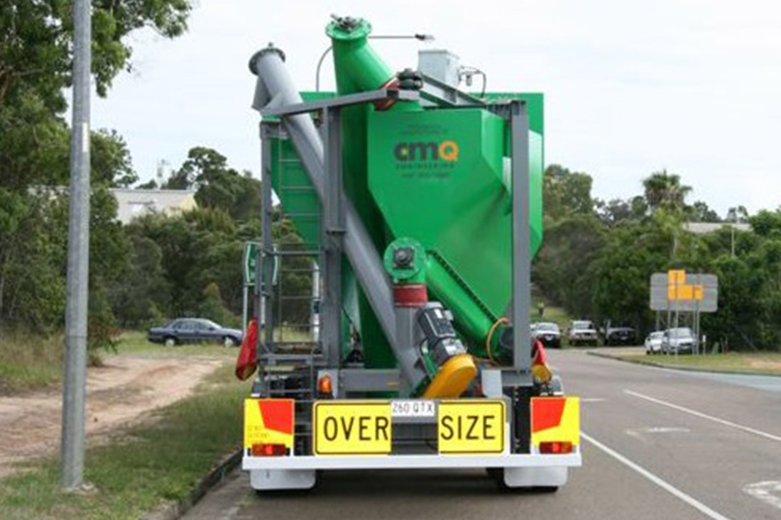Rear view of a green mobile silo on the road | featured image for Mobile Silo & Loss of Weight / Cement Weigh Hopper.