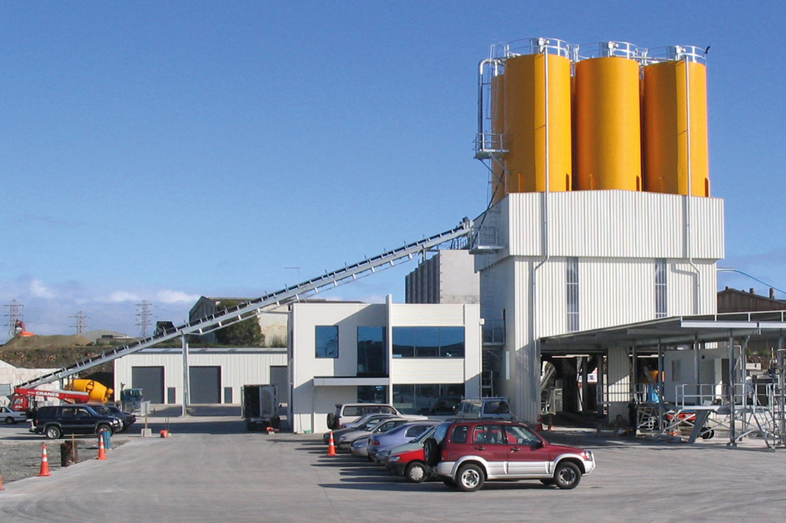 Brand new concrete batching plant facility with yellow-orange silos | Featured image for the Concrete Batching Plants products from CMQ Engineering.