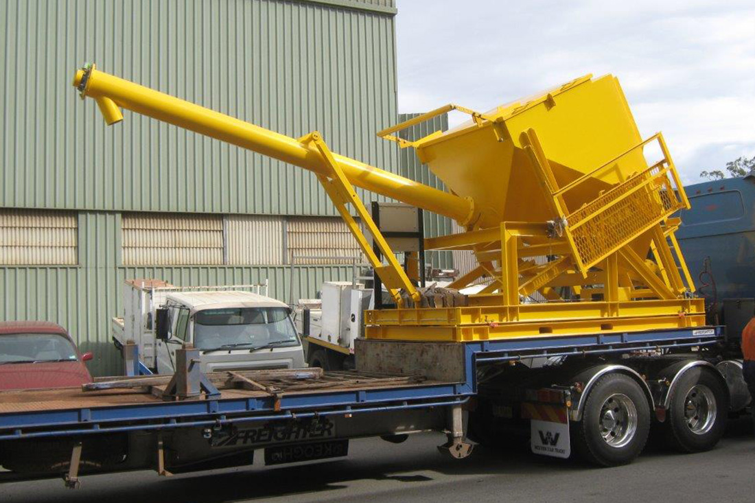 Photo of a new yellow bulker on a semi | featured image for Bulker Bag Unloader & Auger.