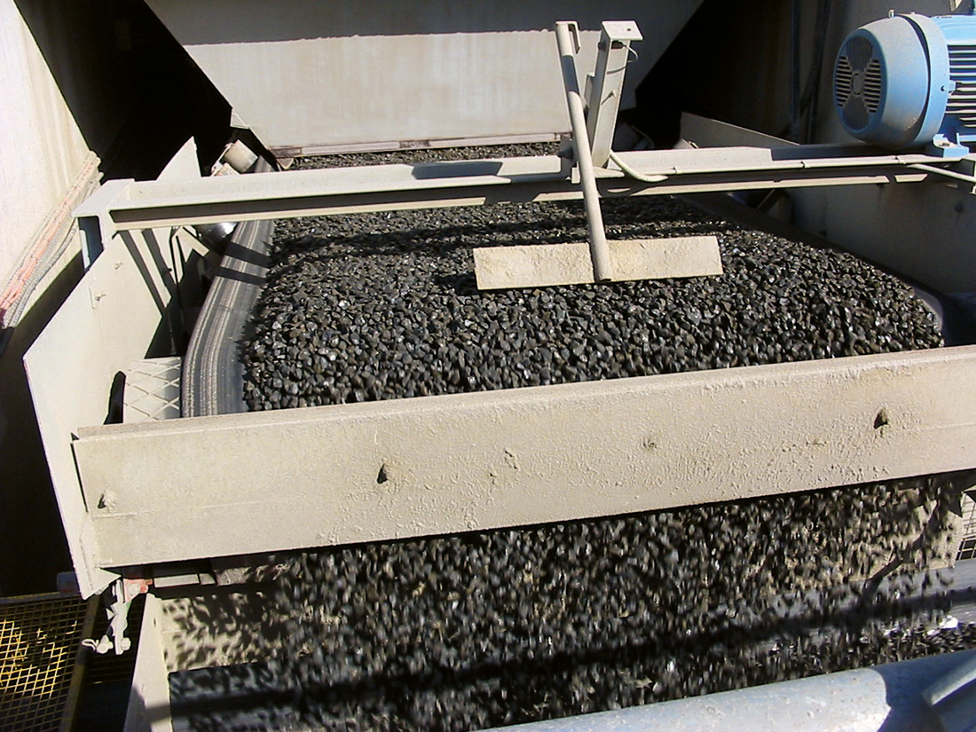 Up close photo of a truck unloader processing small stones | featured image for Truck / Railwagon Unloader.