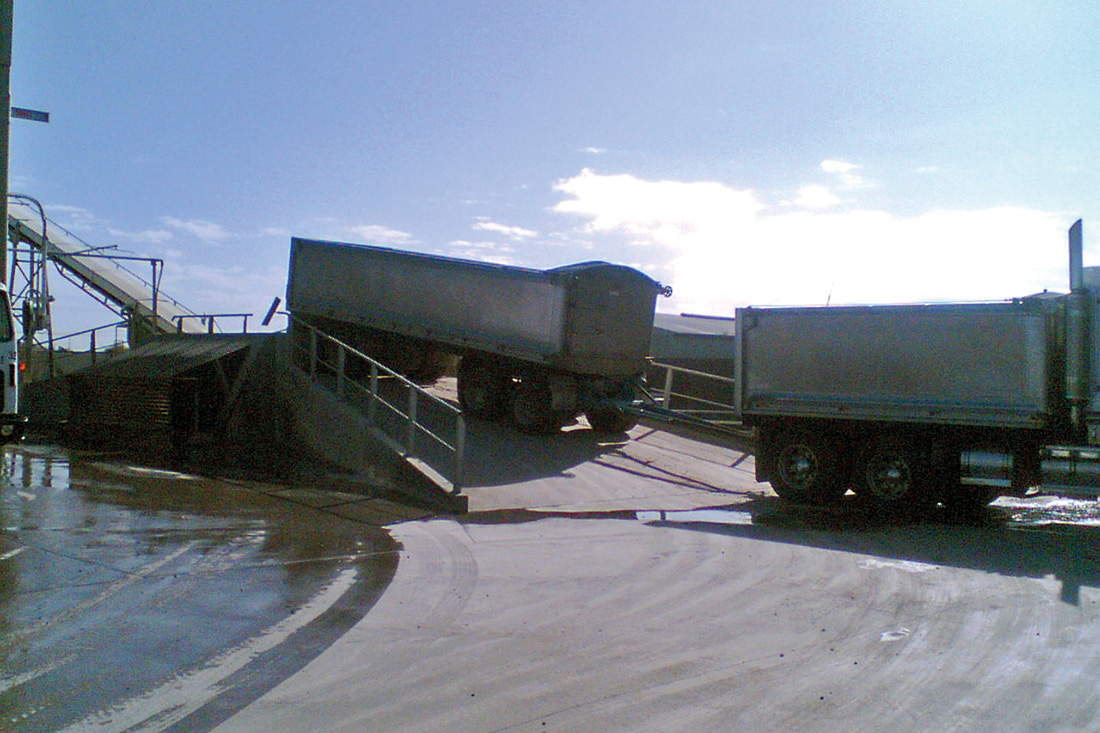 Photo of newly filled trucks hauling product | featured image for Truck / Railwagon Unloader.